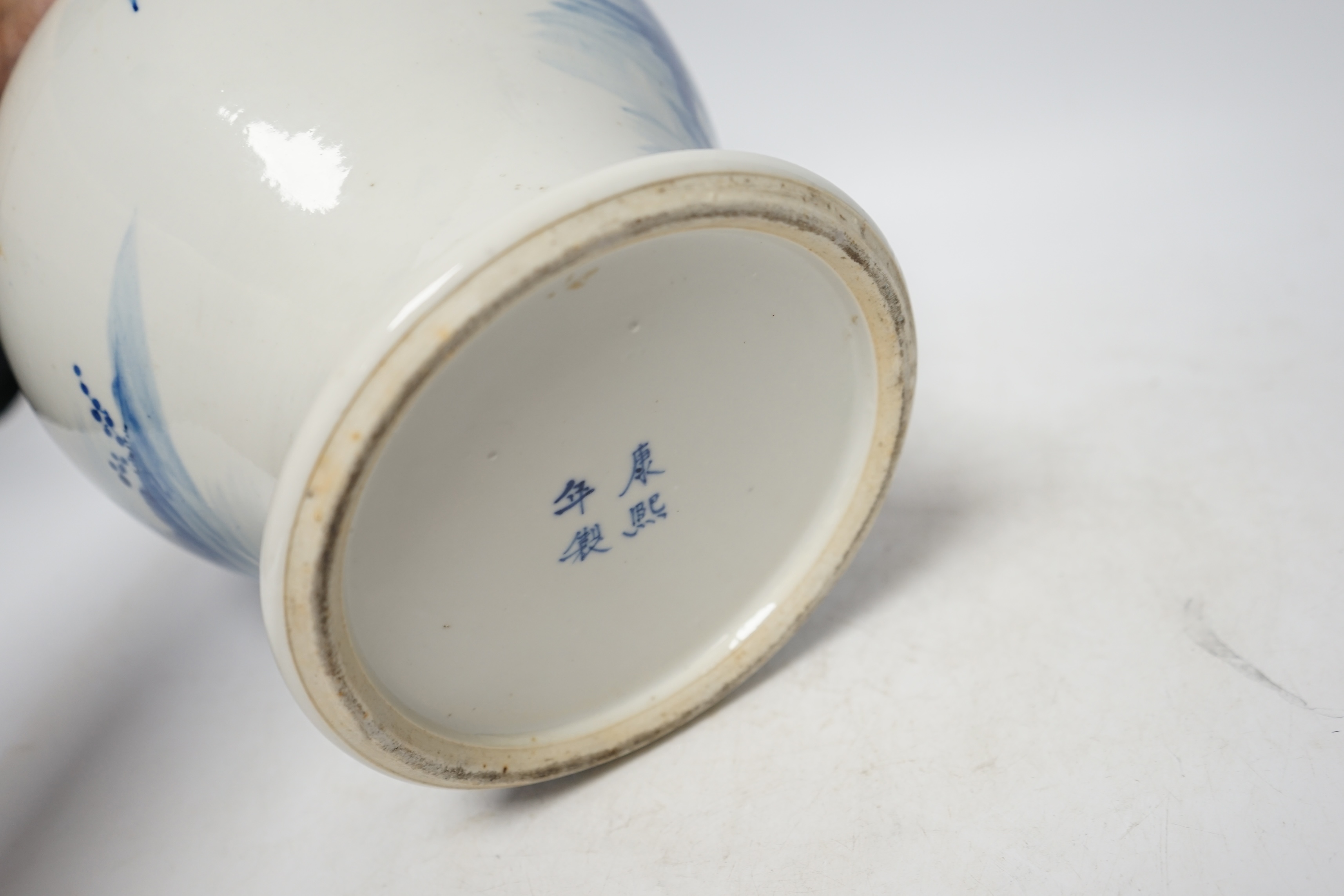 A 19th century Chinese blue and white baluster jar, painted with a dignitary and attendants at a table with objects in a garden setting, wood cover, 35cm. Condition - good
